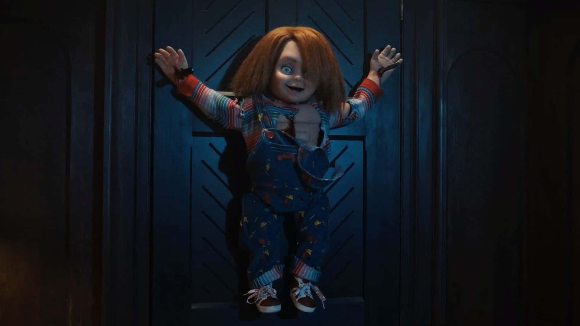 Chucky Doll Impaled On A Door Background