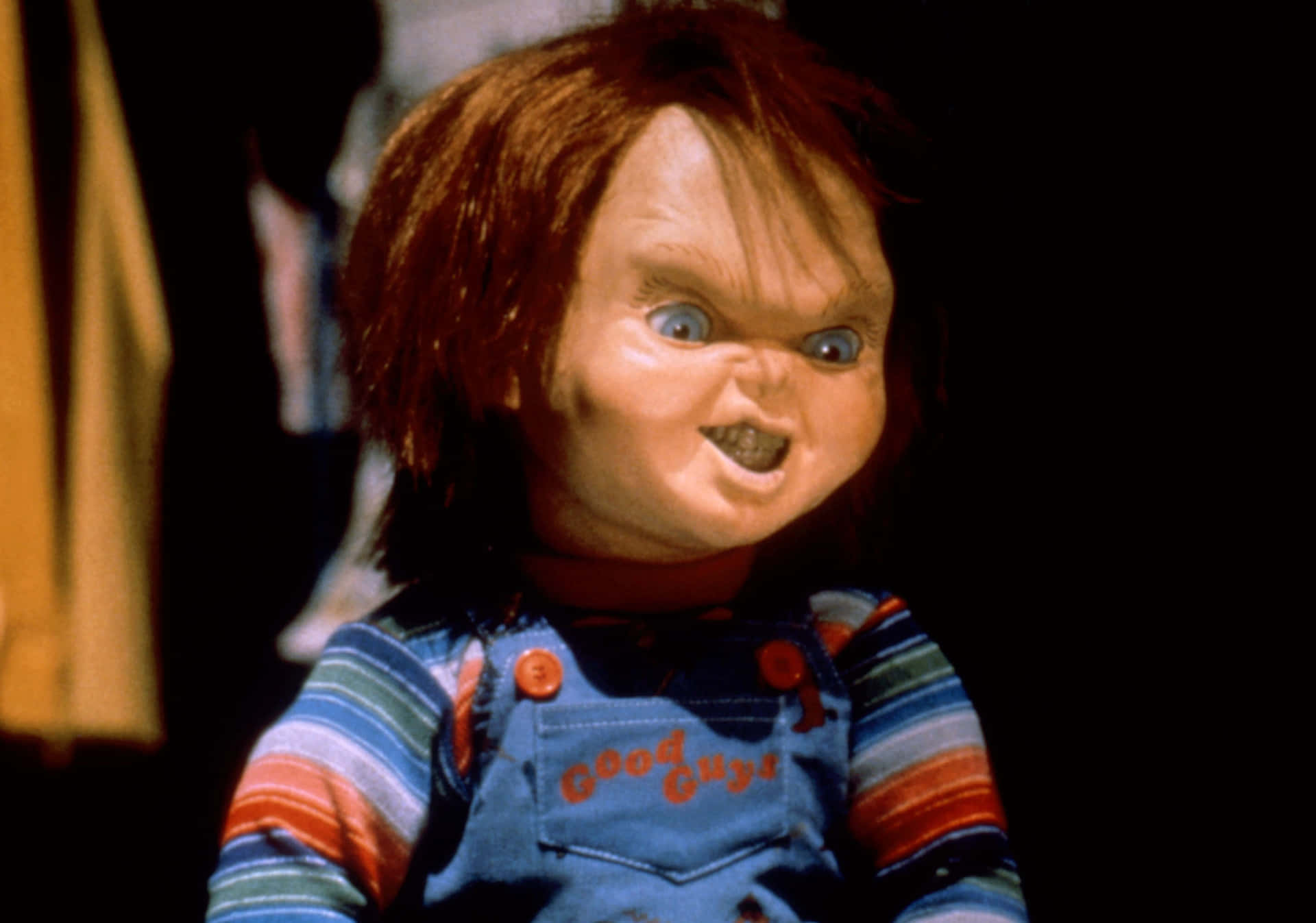 Chucky Doll Scrunching Up His Face Background