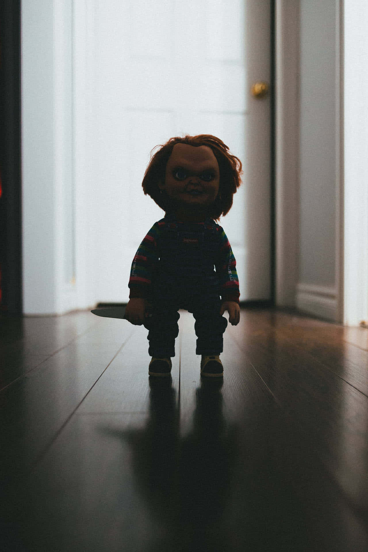 Chucky Doll Standing In The Hallway Background