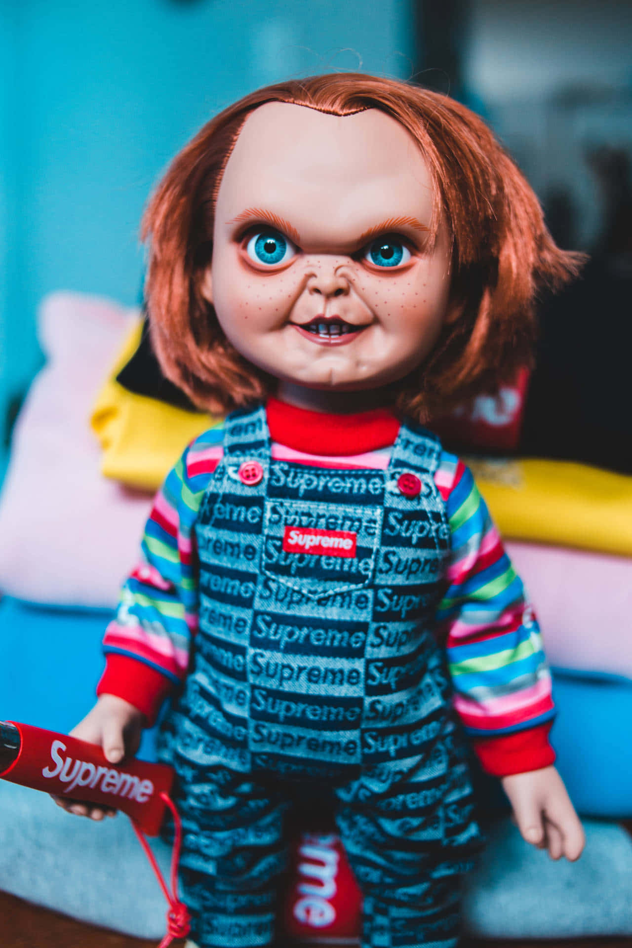 Chucky Doll With Colorful Blankets Background