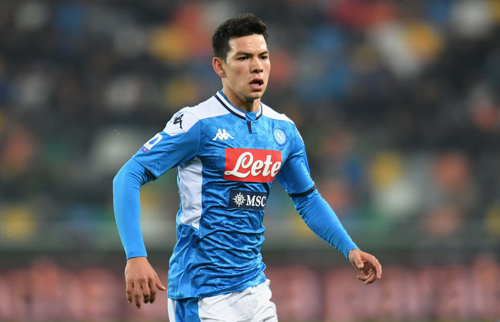 Chucky Lozano In Action On The Soccer Field Background