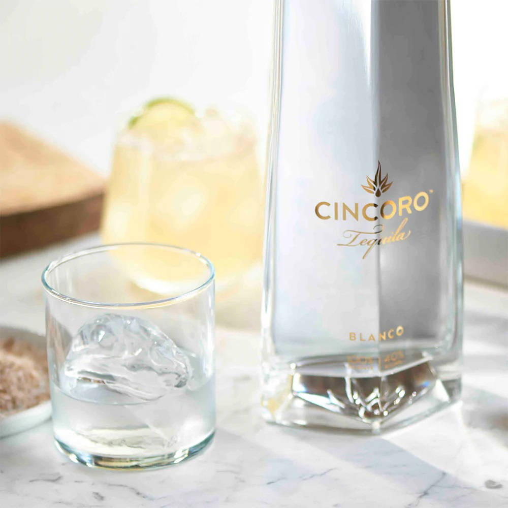 Cincoro Tequila Blanco And Glass With Ice Background