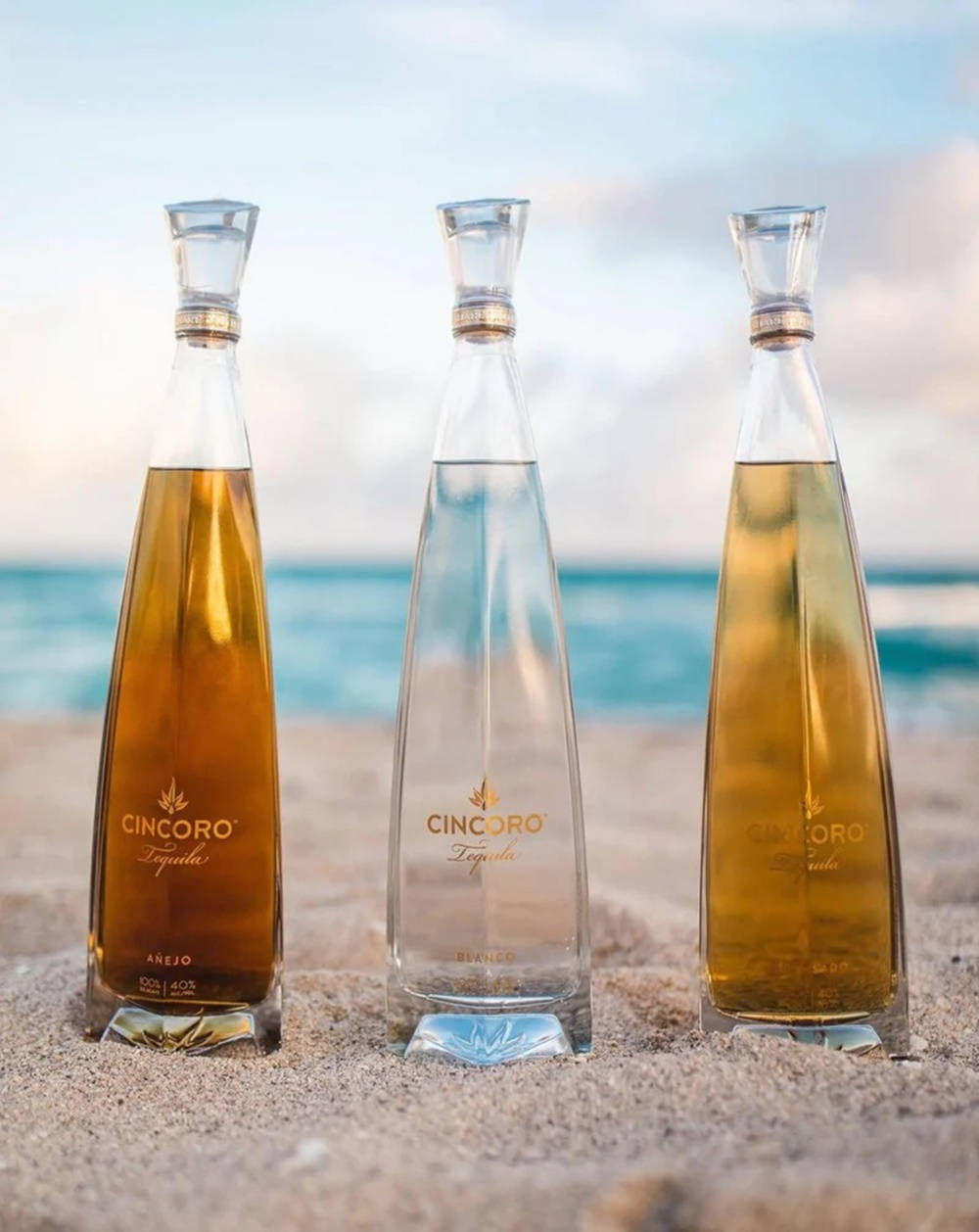 Cincoro Tequila Bottle At Beach Background