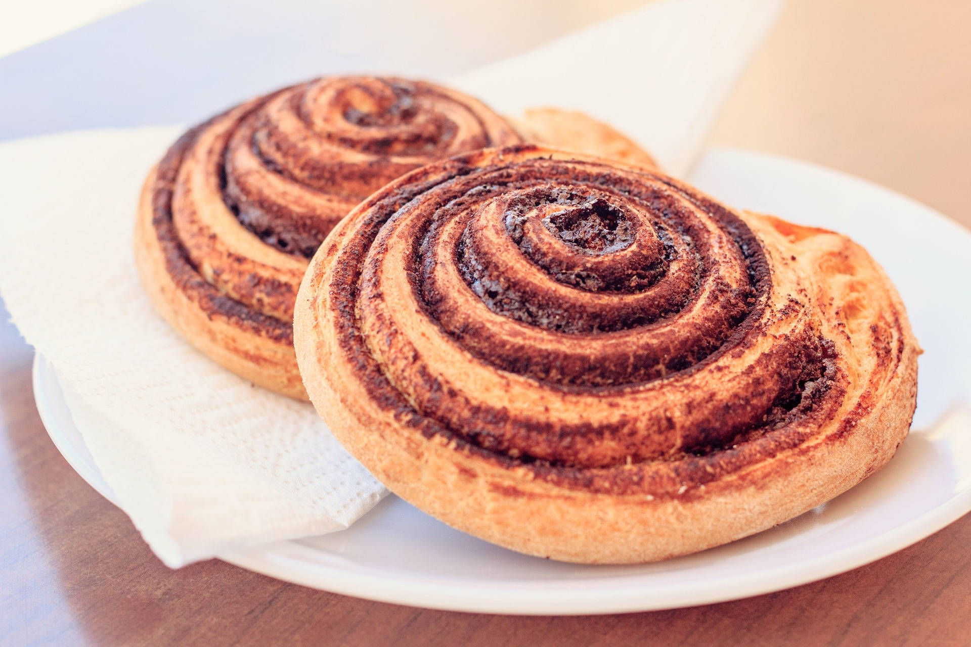 Cinnamon Rolls On A Simple Pastry Plate Background