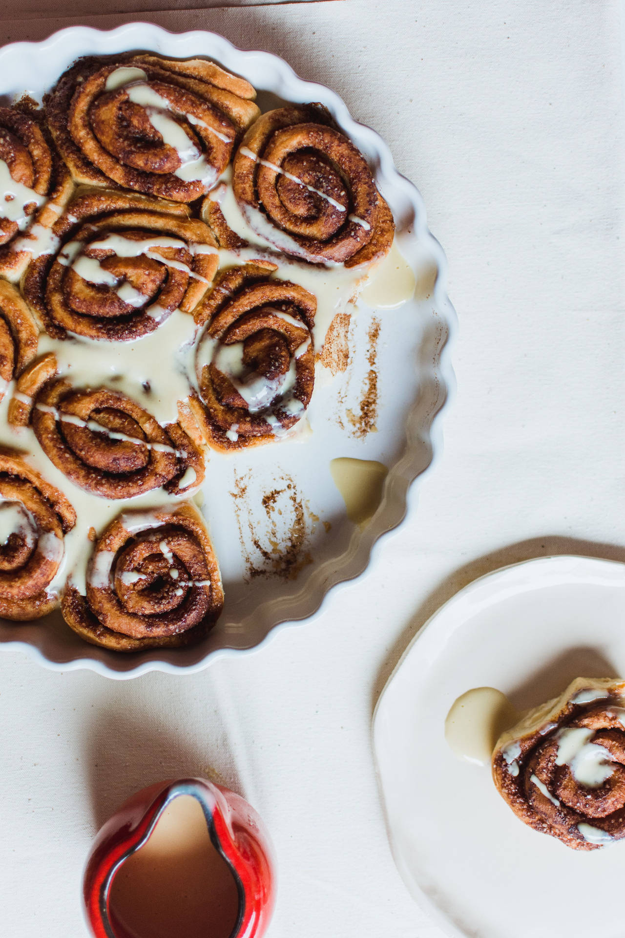 Cinnamon Rolls Topped With Milk Background