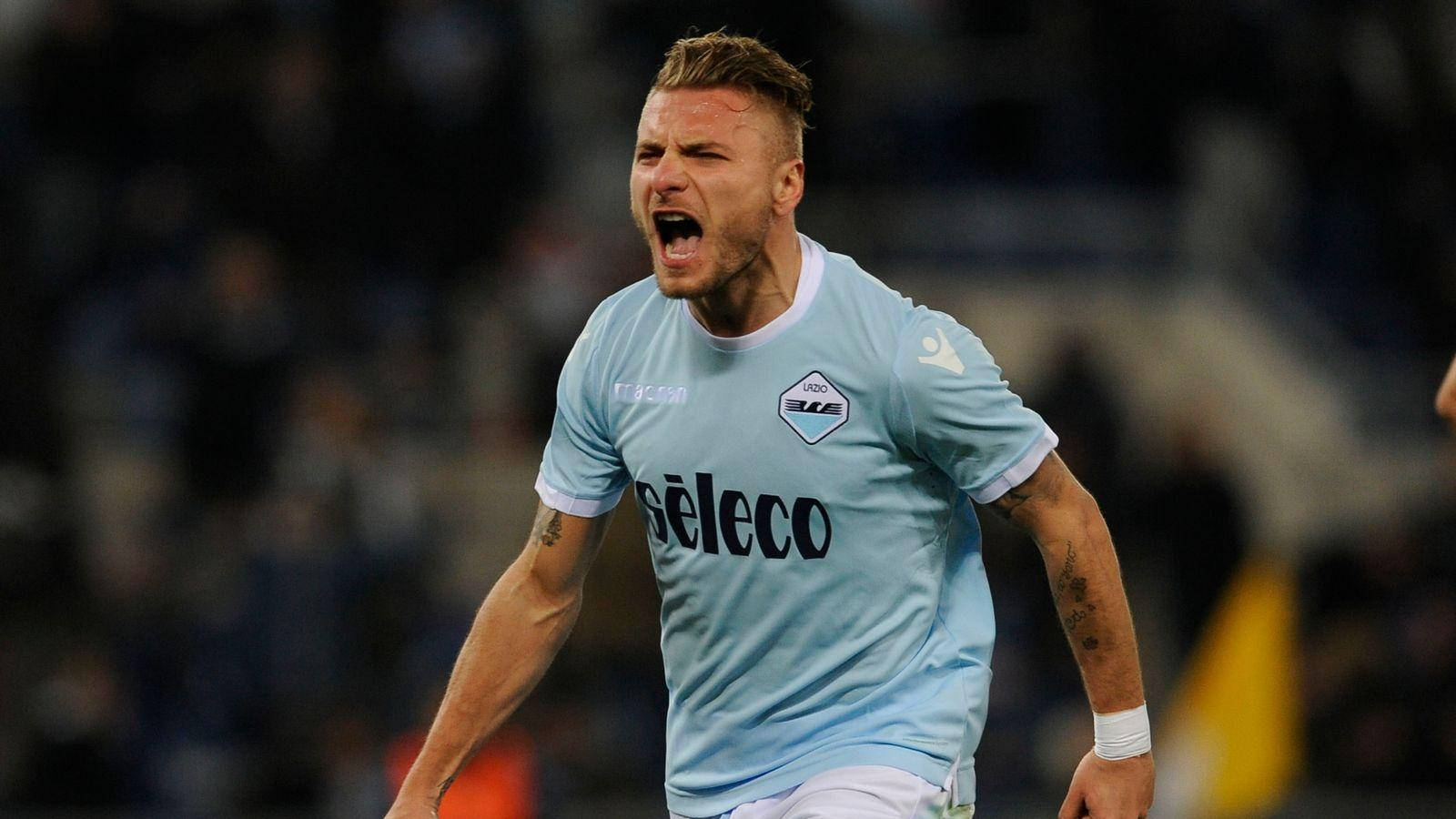 Ciro Immobile In Action On The Football Field Background