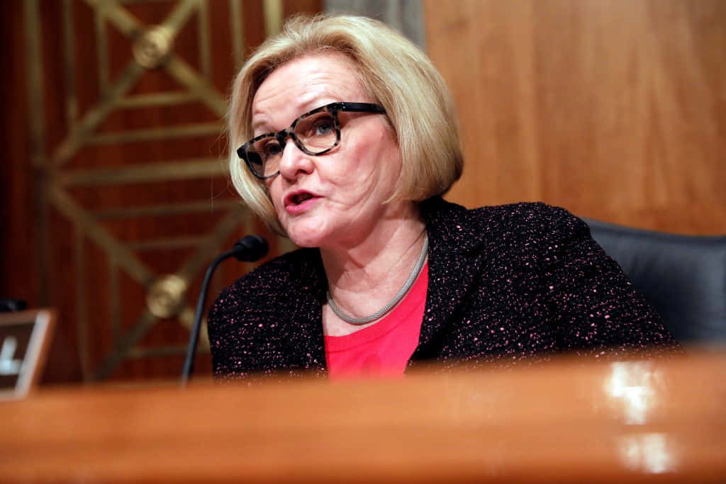Claire Mccaskill Sophisticated In A Black Coat Background