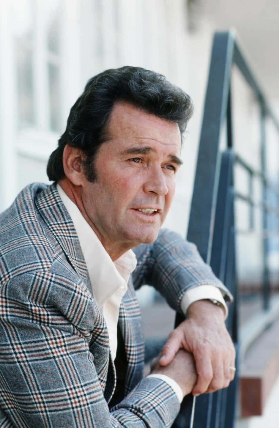 Classic Hollywood Actor Leaningon Railing Background