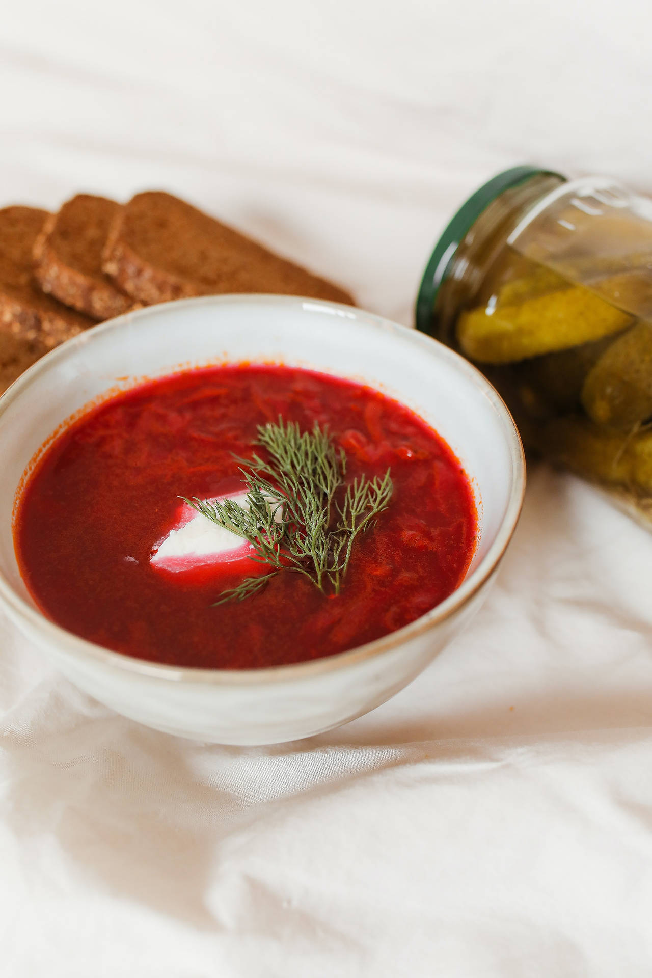 Classic Red Borscht Soup In A White Bowl