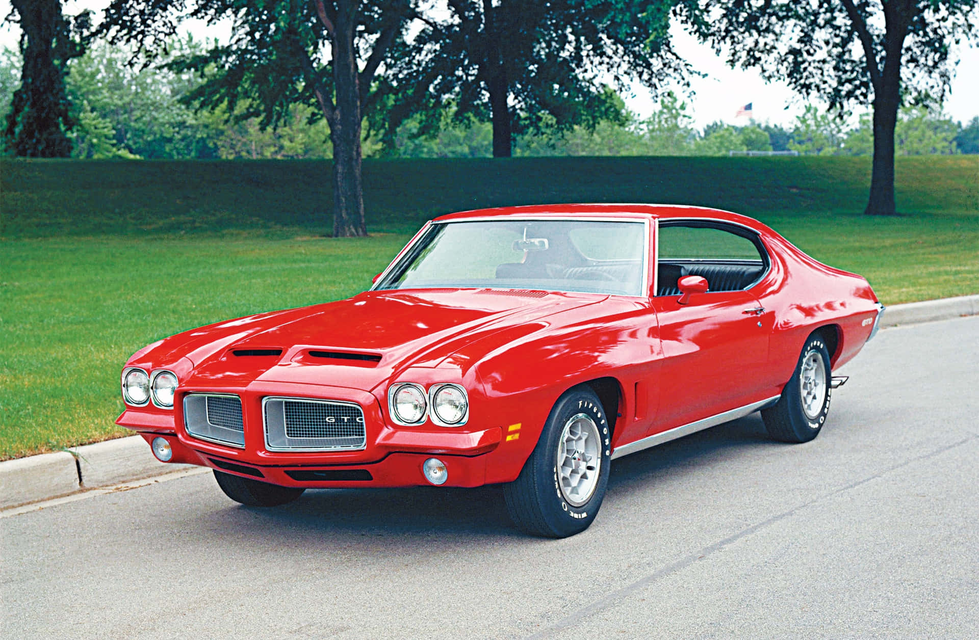 Classic Red Pontiac Gto Muscle Car On A City Street Background