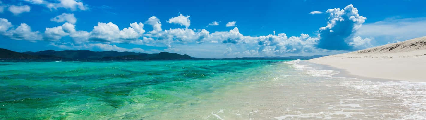Clear Blue Seashore As A Panoramic Desktop Background