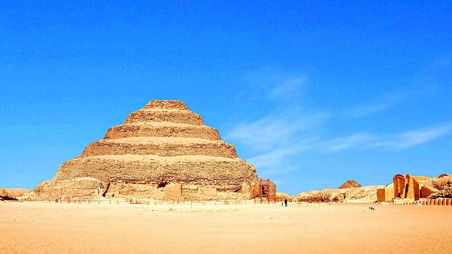Clear Skies Over Saqqara Pyramid Background