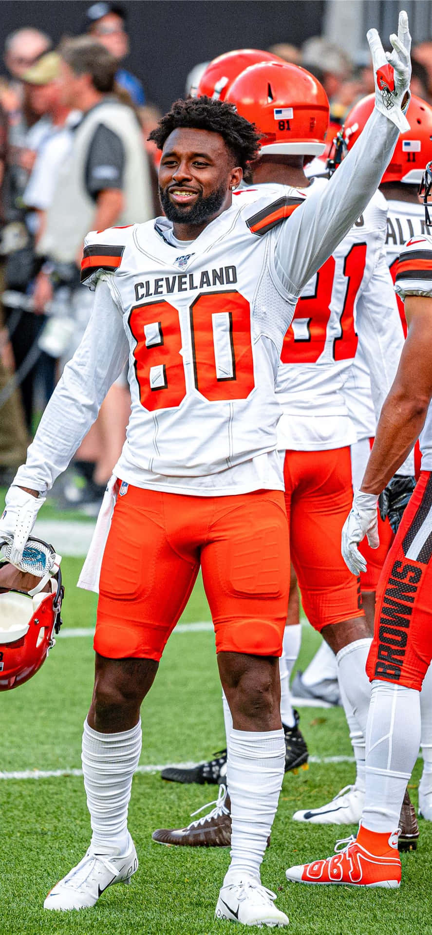 Cleveland Browns Player Celebrating On Field Background