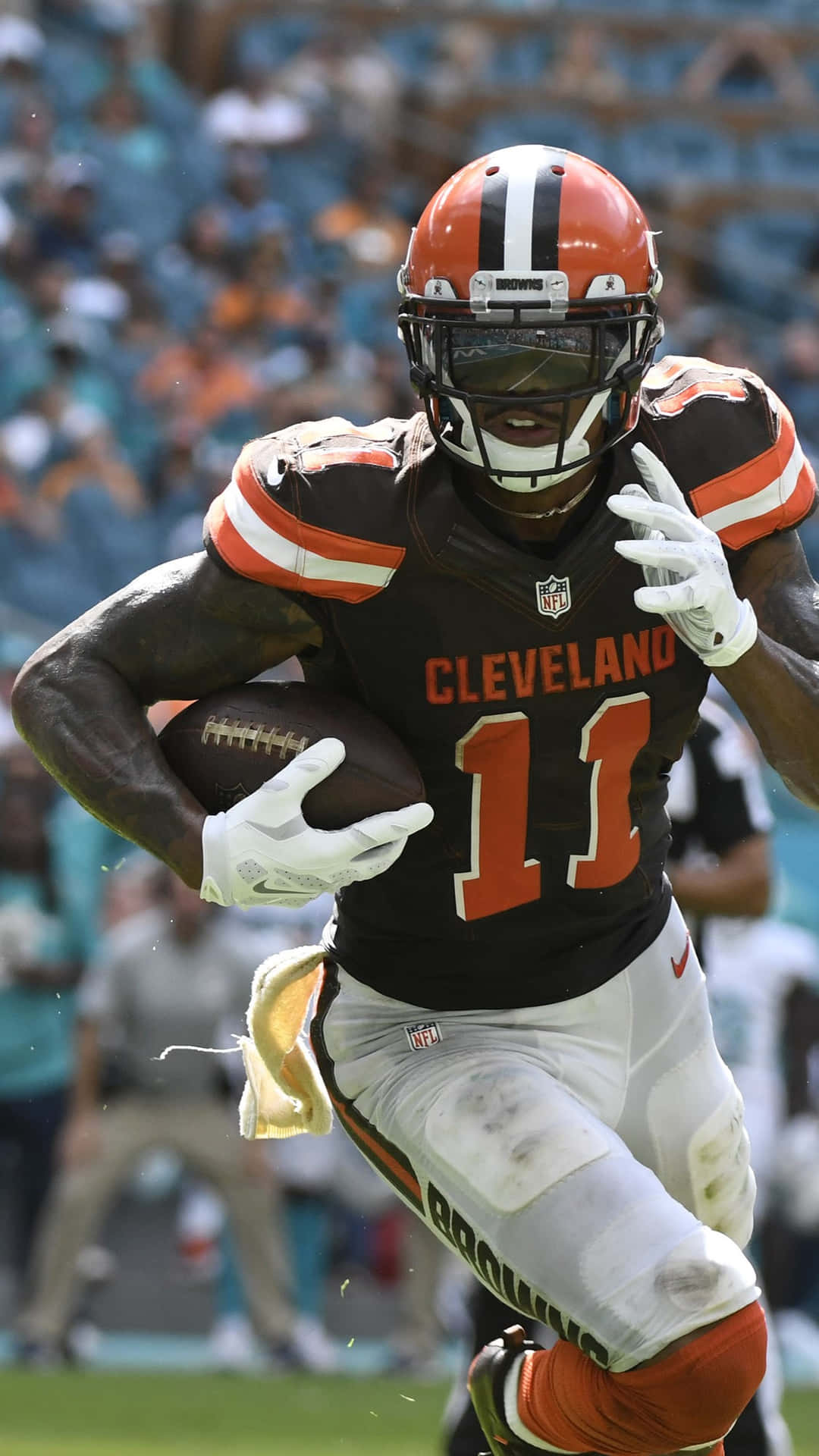 Cleveland Browns Player Running With Football Background