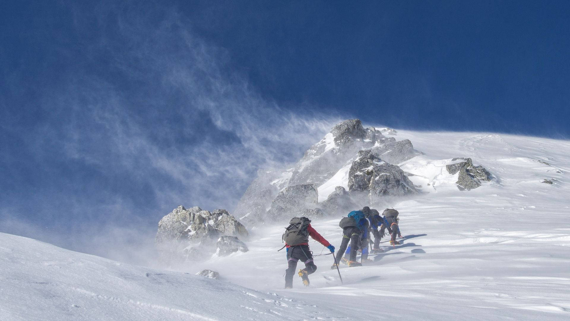 Climbing Group On Snowy Mountain Background