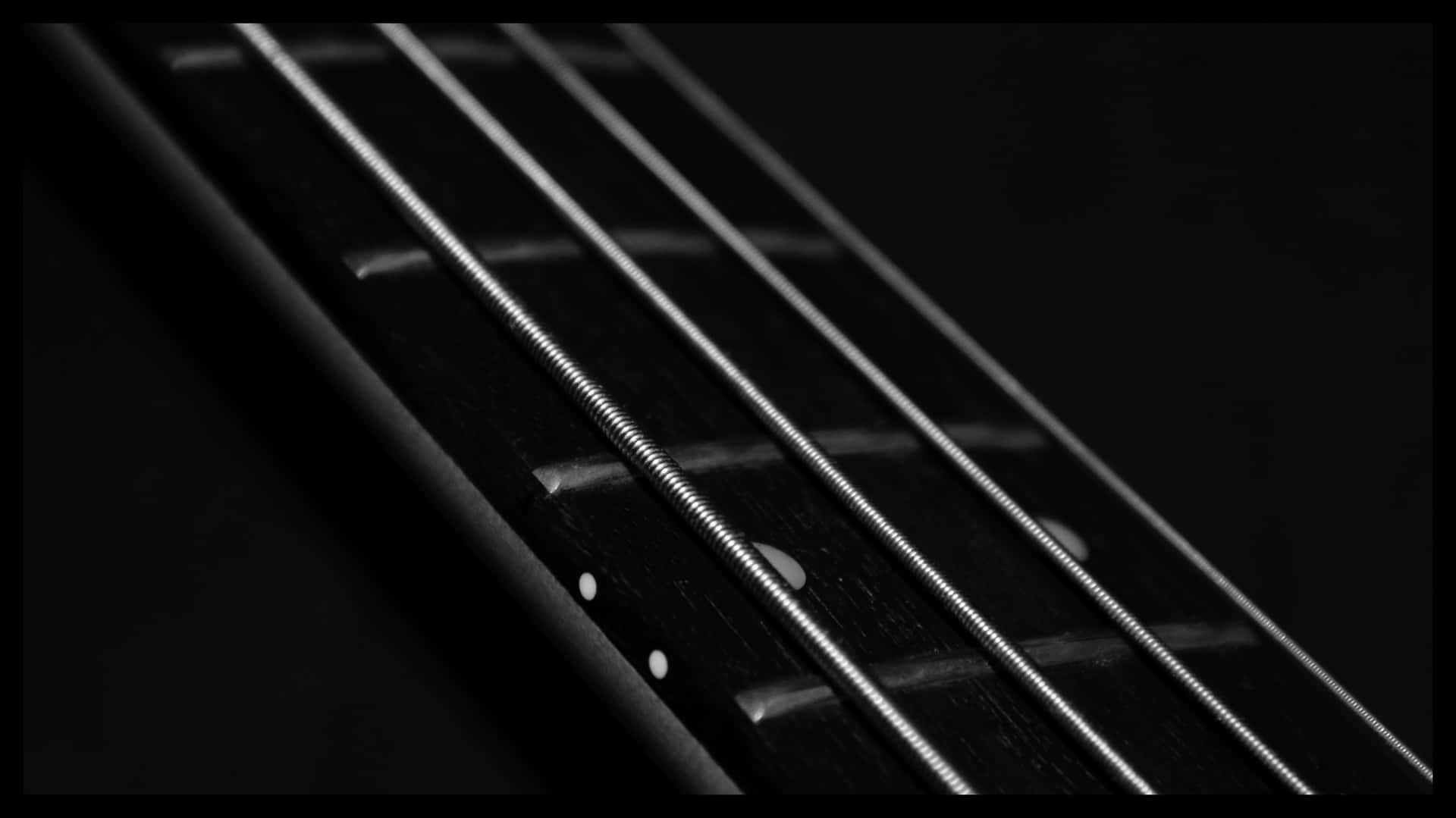 Close Up Image Of An Enticing Black Bass Guitar