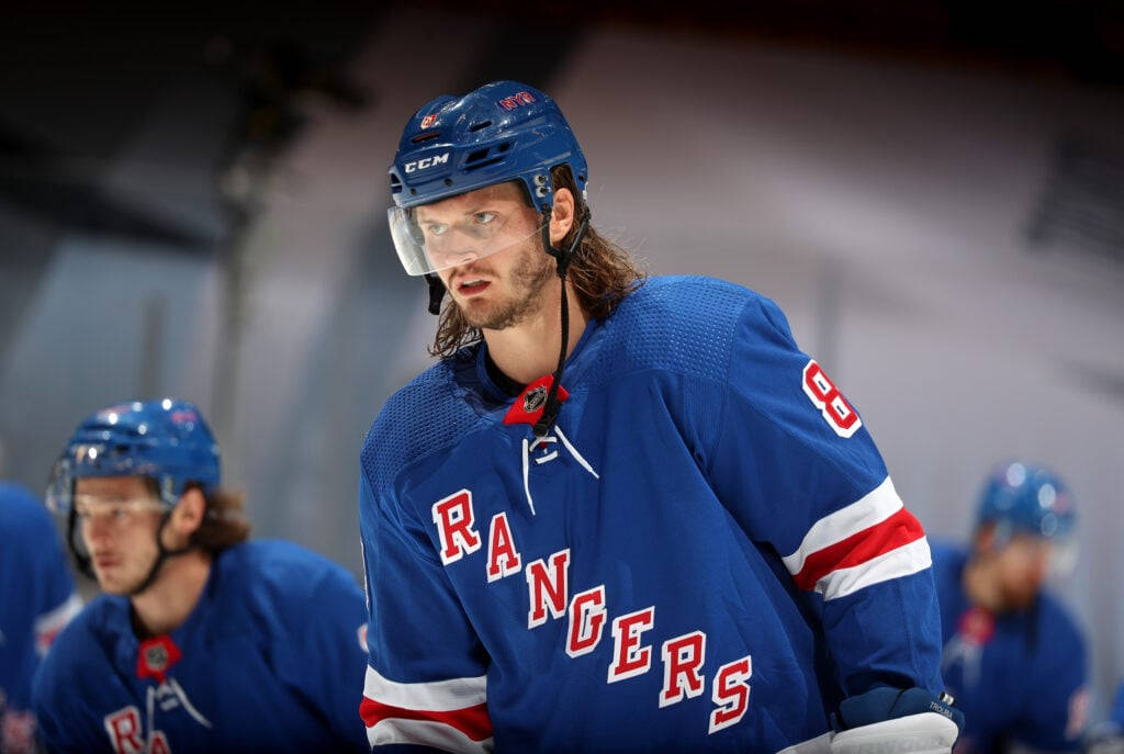 Close Up Look Of Jacob Trouba Looking To The Right With Teammates Background