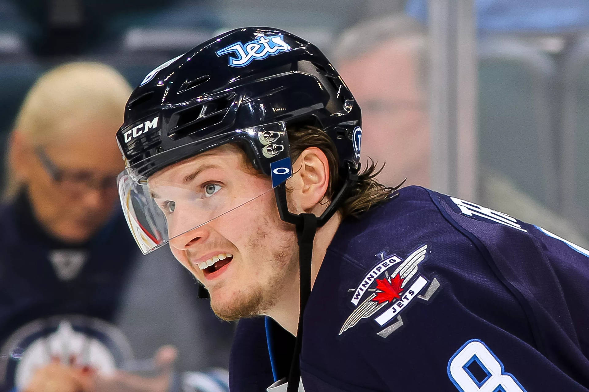 Close Up Look Of Jacob Trouba Smiling While Watching The Game Background