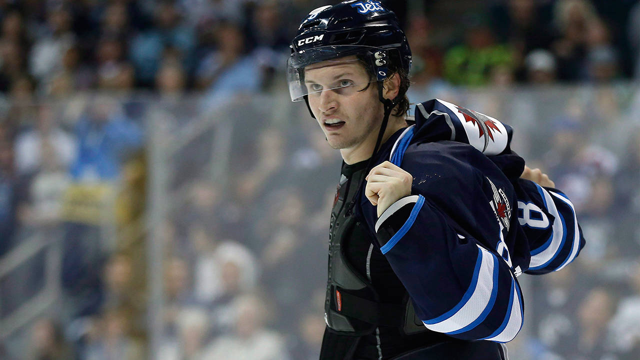 Close Up Look Of Jacob Trouba With A Confused Expression And Jersey Half Removed Background