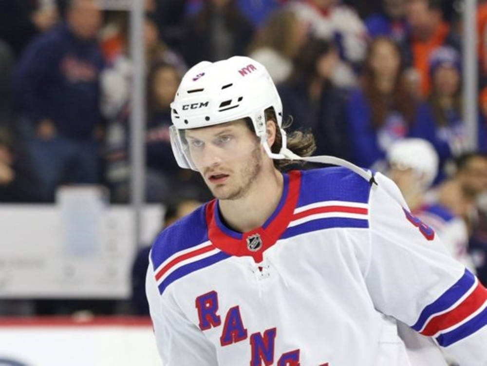 Close Up Look Of Jacob Trouba With Serious Expression During Game Background