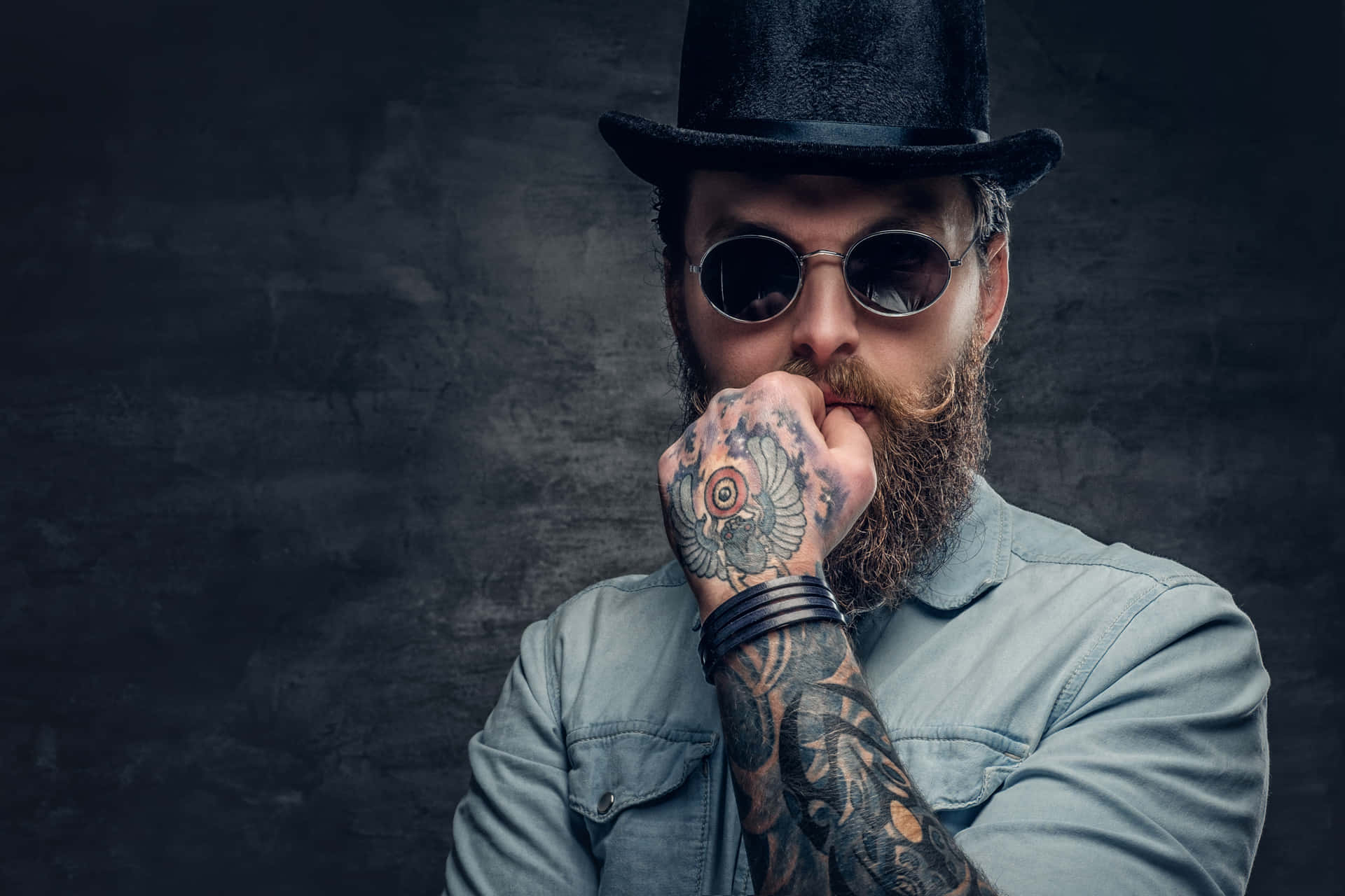 Close-up Of A Bearded Man Showcasing Intricate Hand Tattoo