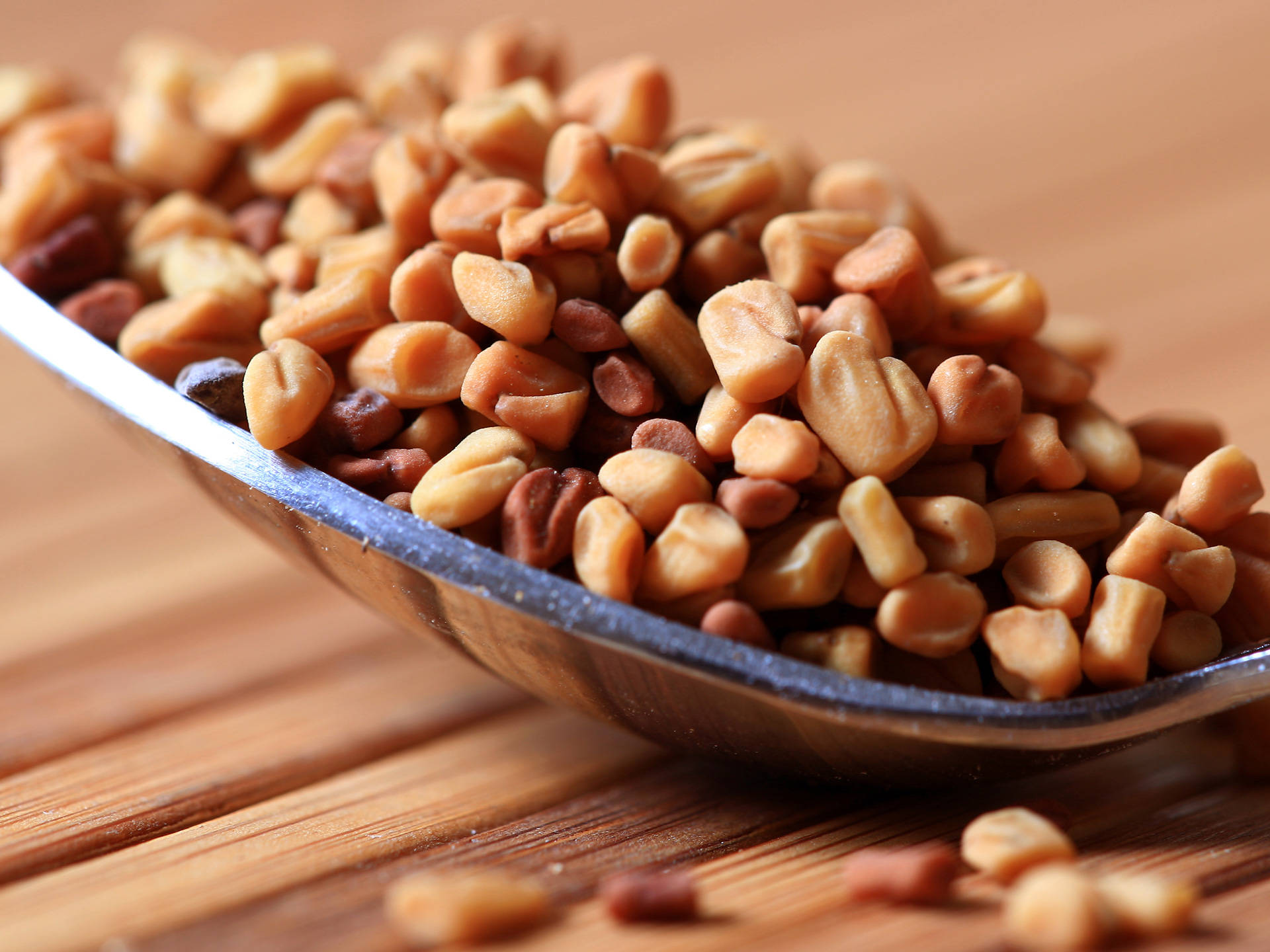 Close Up Of A Spoon With Fenugreek Seeds Background