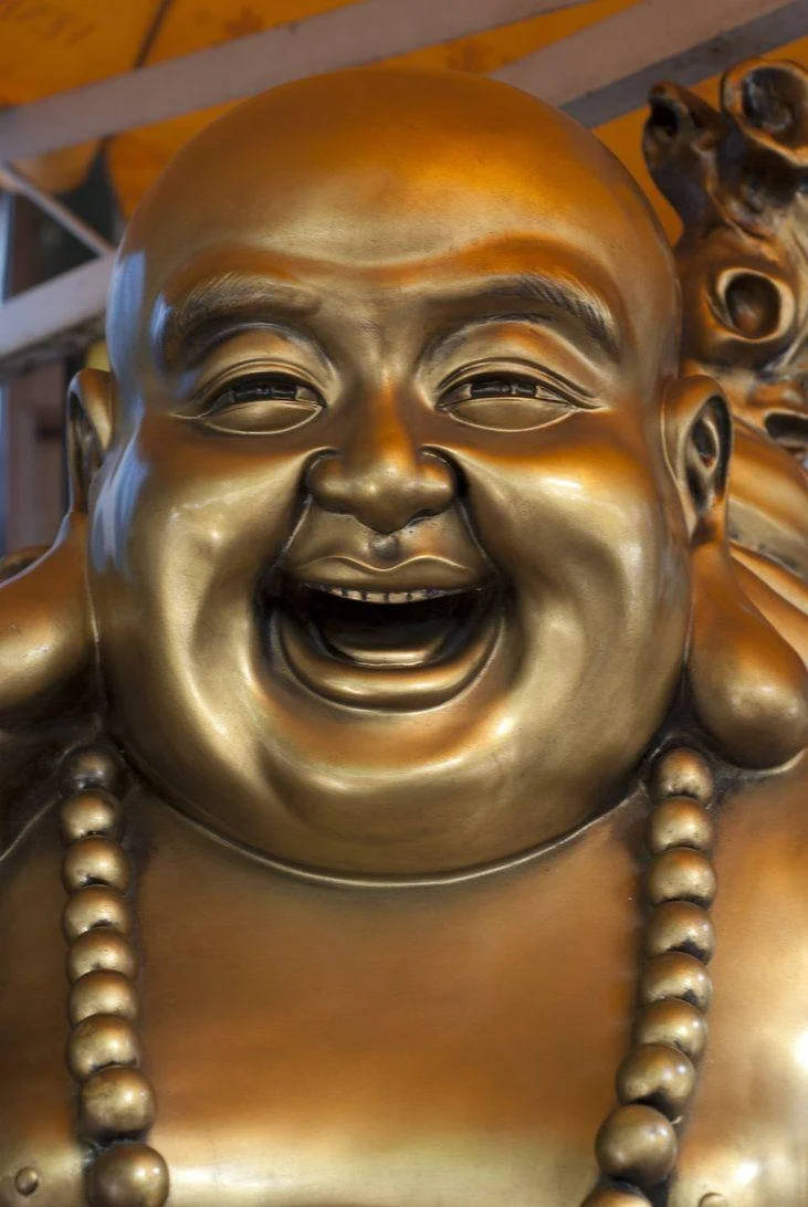 Close-up Of Golden Laughing Buddha Statue Background