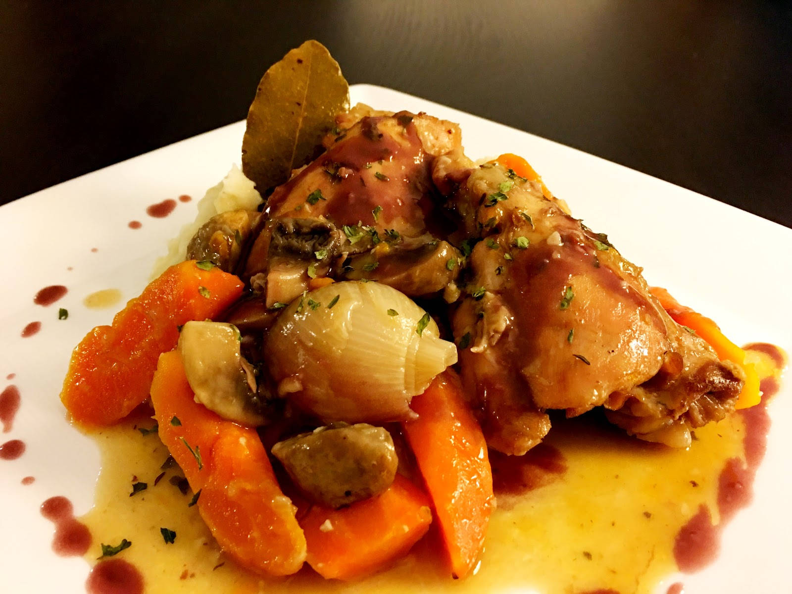 Close-up Photograph Of A Garnished Coq Au Vin