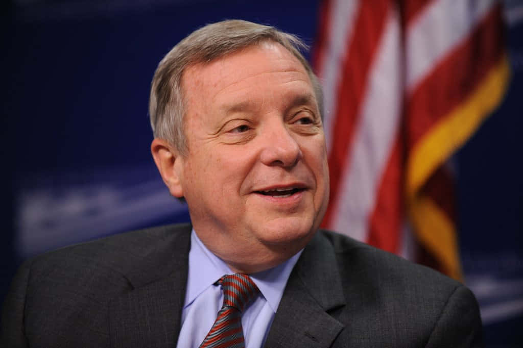 Close-up Portrait Of Richard Durbin With A Smiling Expression Background