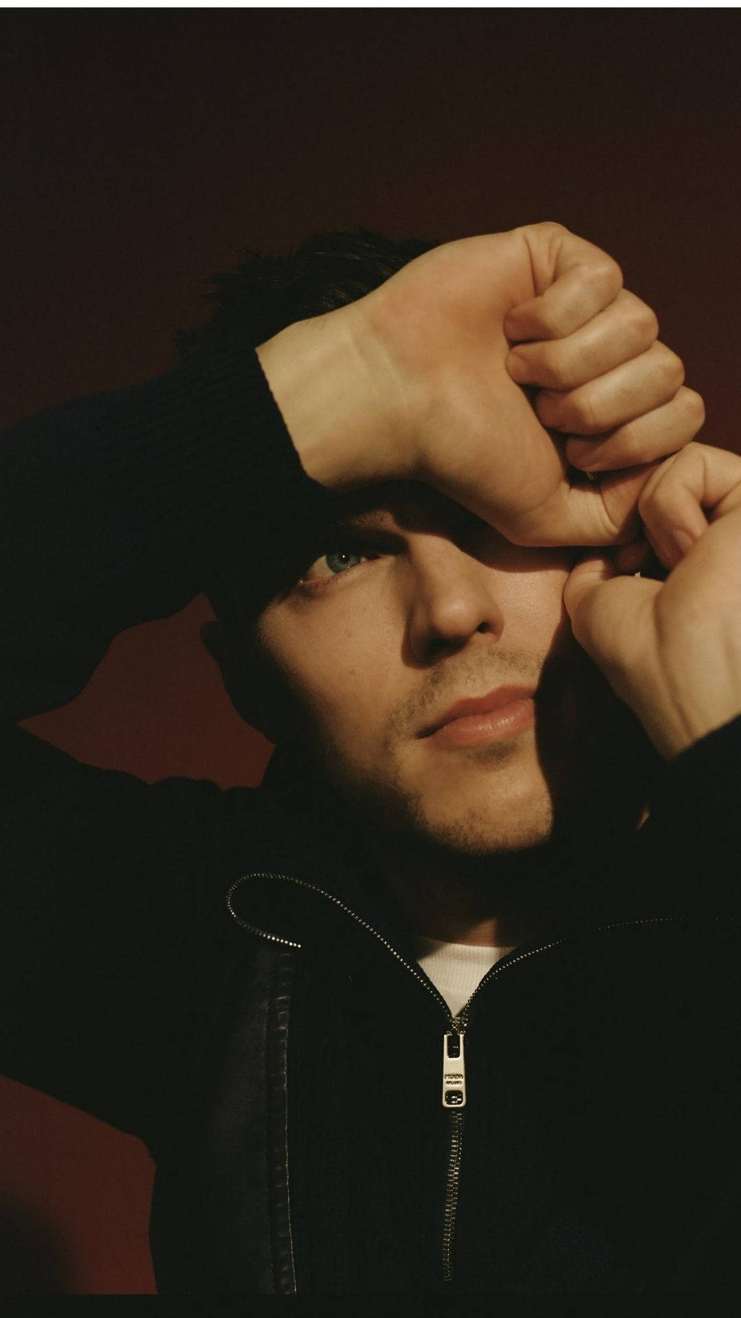 Close-up Shot Of Nicholas Hoult Covering One Eye With Hand. Background