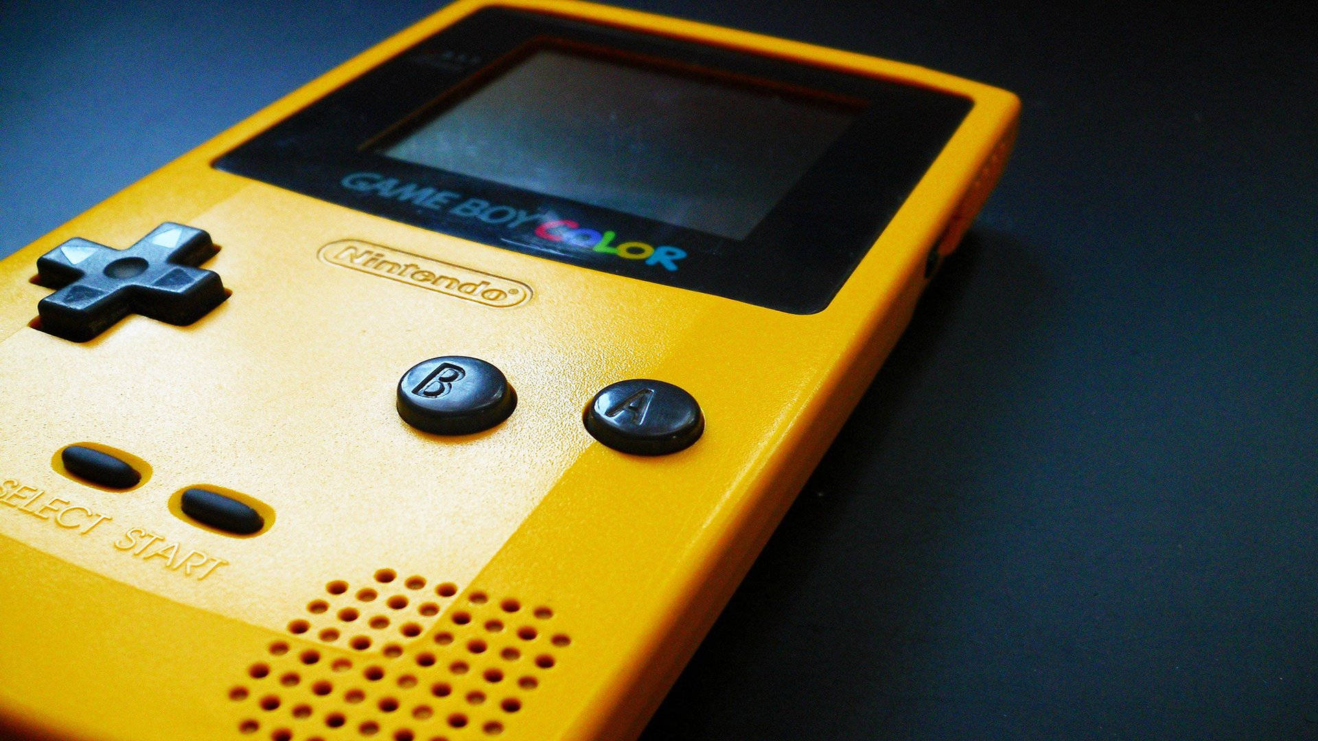Close-up Shot Of Yellow Game Boy Color Background