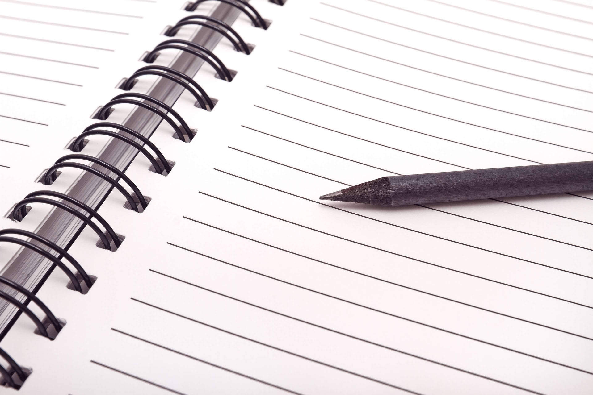 Close-up View Of A Blank Page In A Spiral Notebook With A Pen Alongside. Background