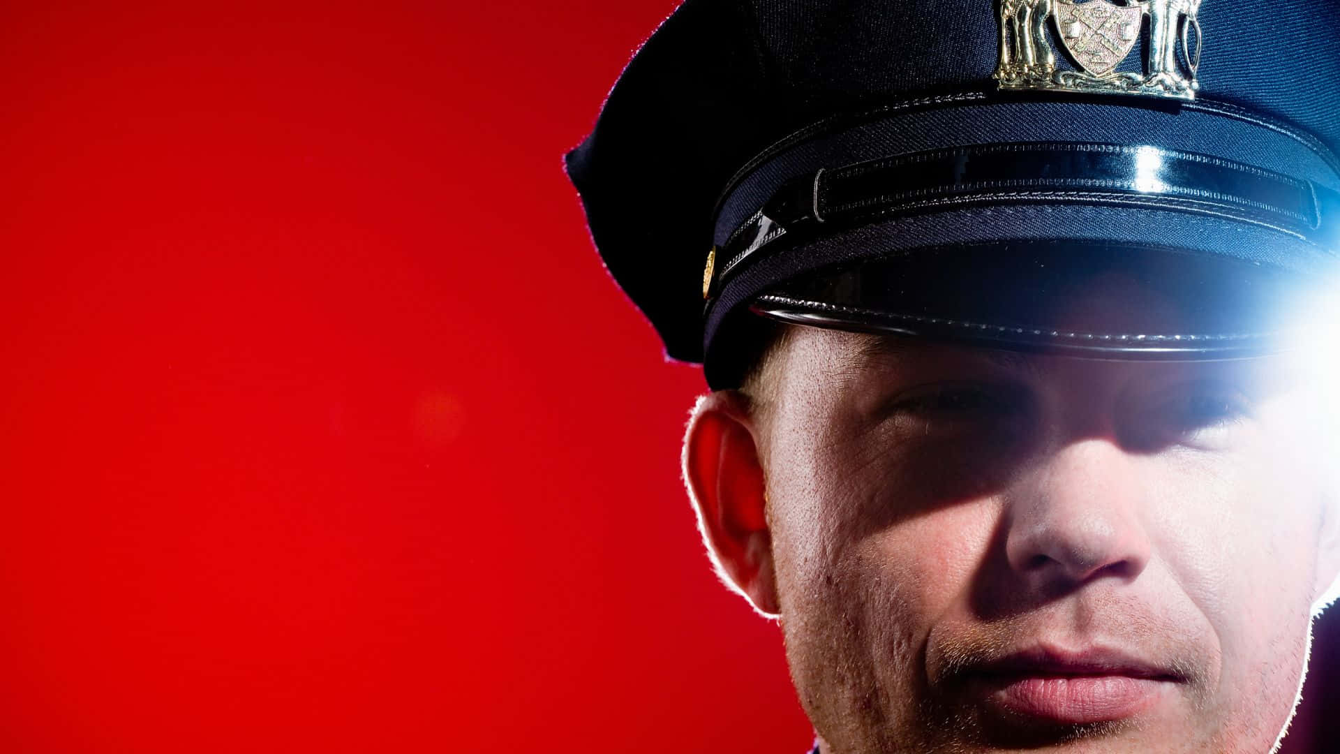Close Up View Of Cop Officer In Red Background Background