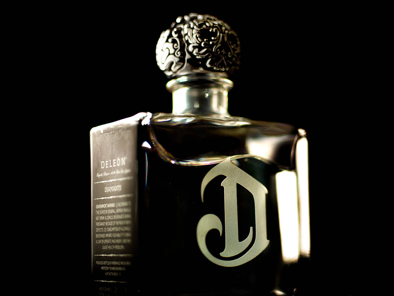 Close-up View Of Deleon Tequila Bottle And Logo