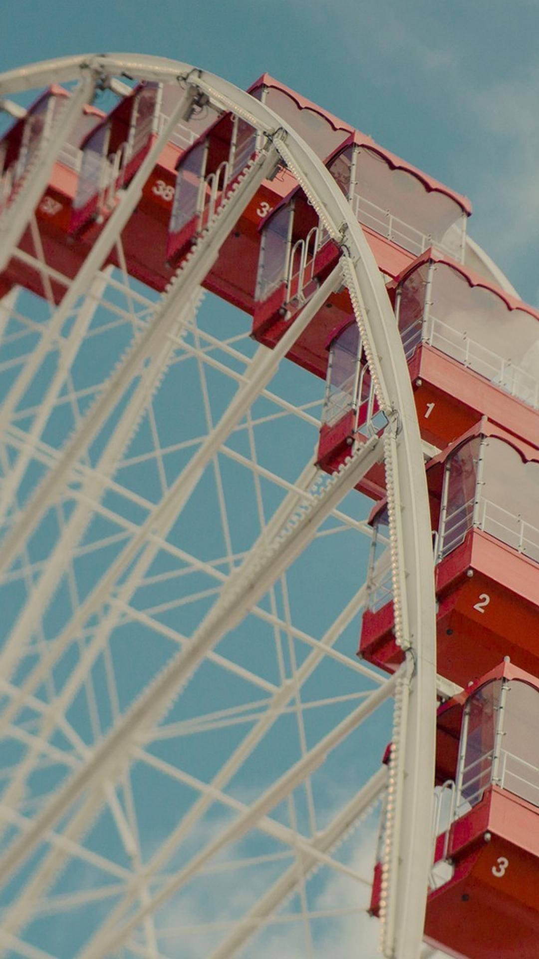 Closeup Ferris Wheel With Red Pods Background