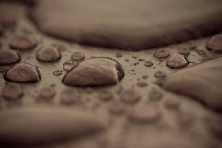 Closeup Of Water Droplets On Wood Background
