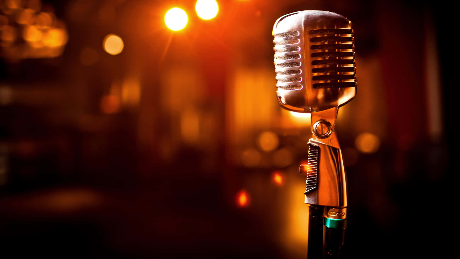 Closeup View Of A Carbon Microphone Illuminated By Glaring Lights Background