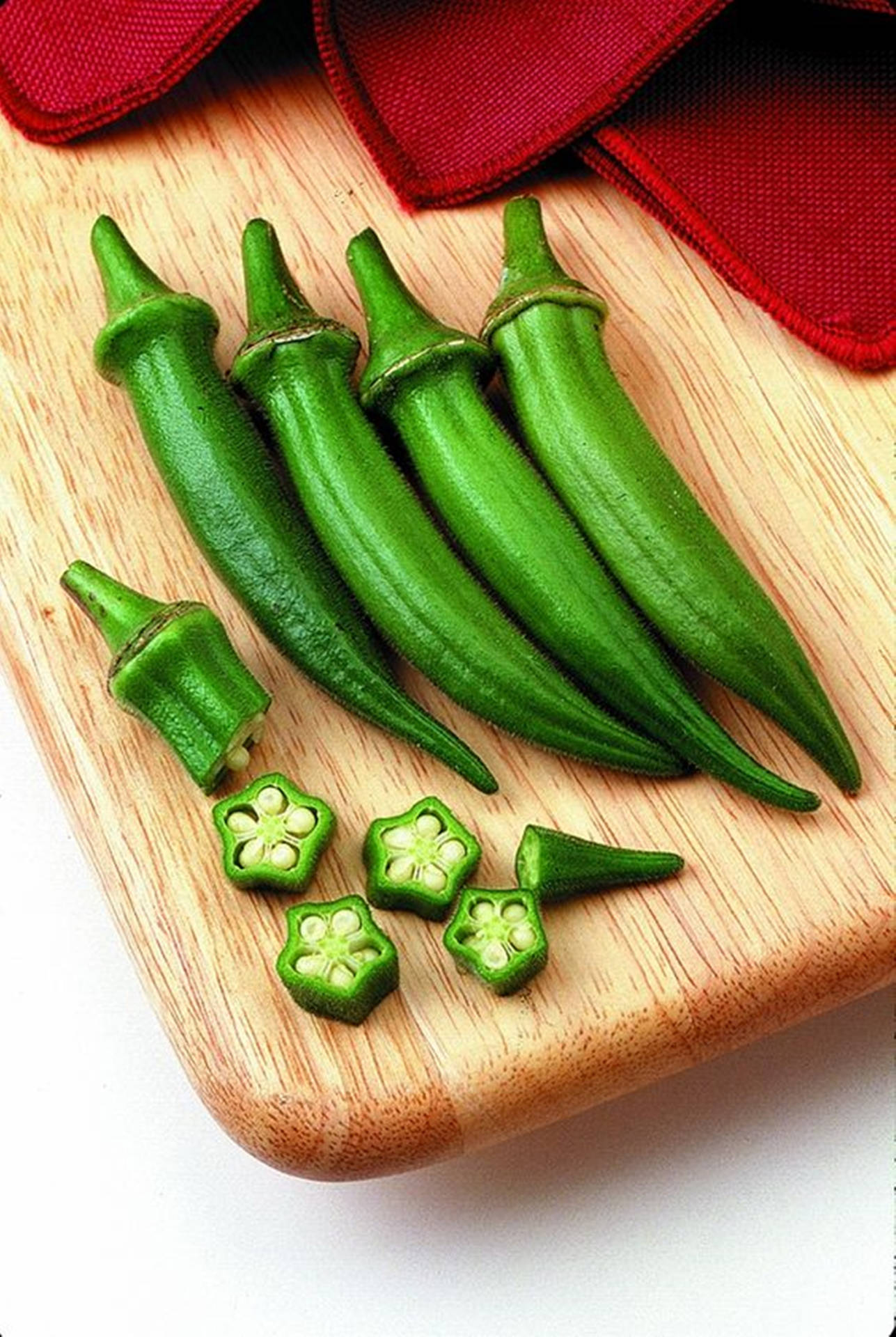 Cloth And Okras On Chopping Board Background