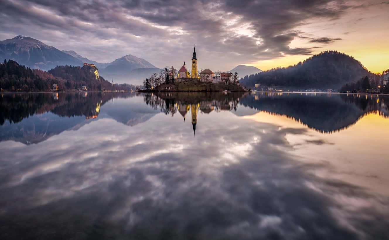 Cloudy Sky Mirrored In Lake Bled