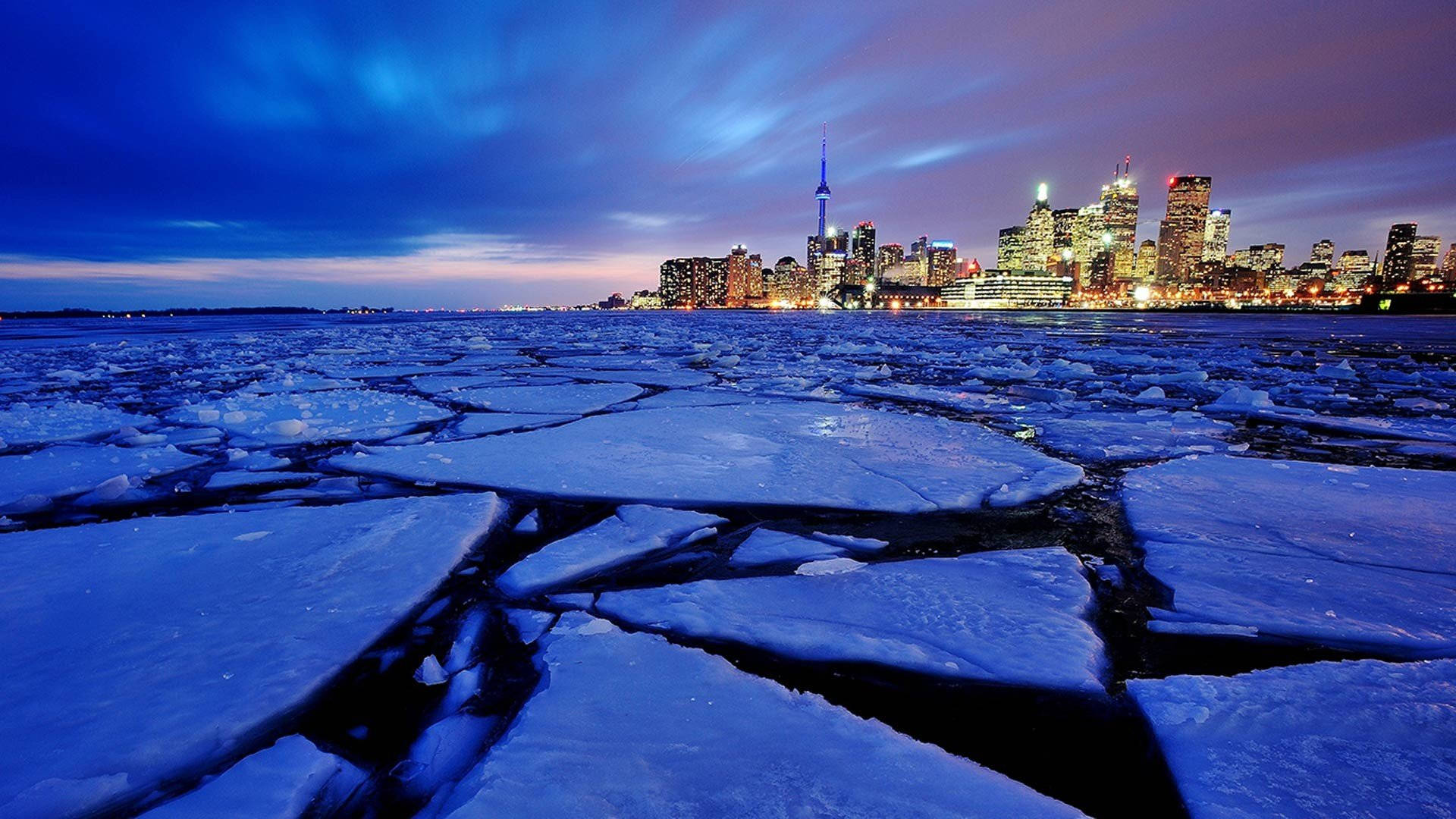 Cn Tower By A Frozen Lake Background