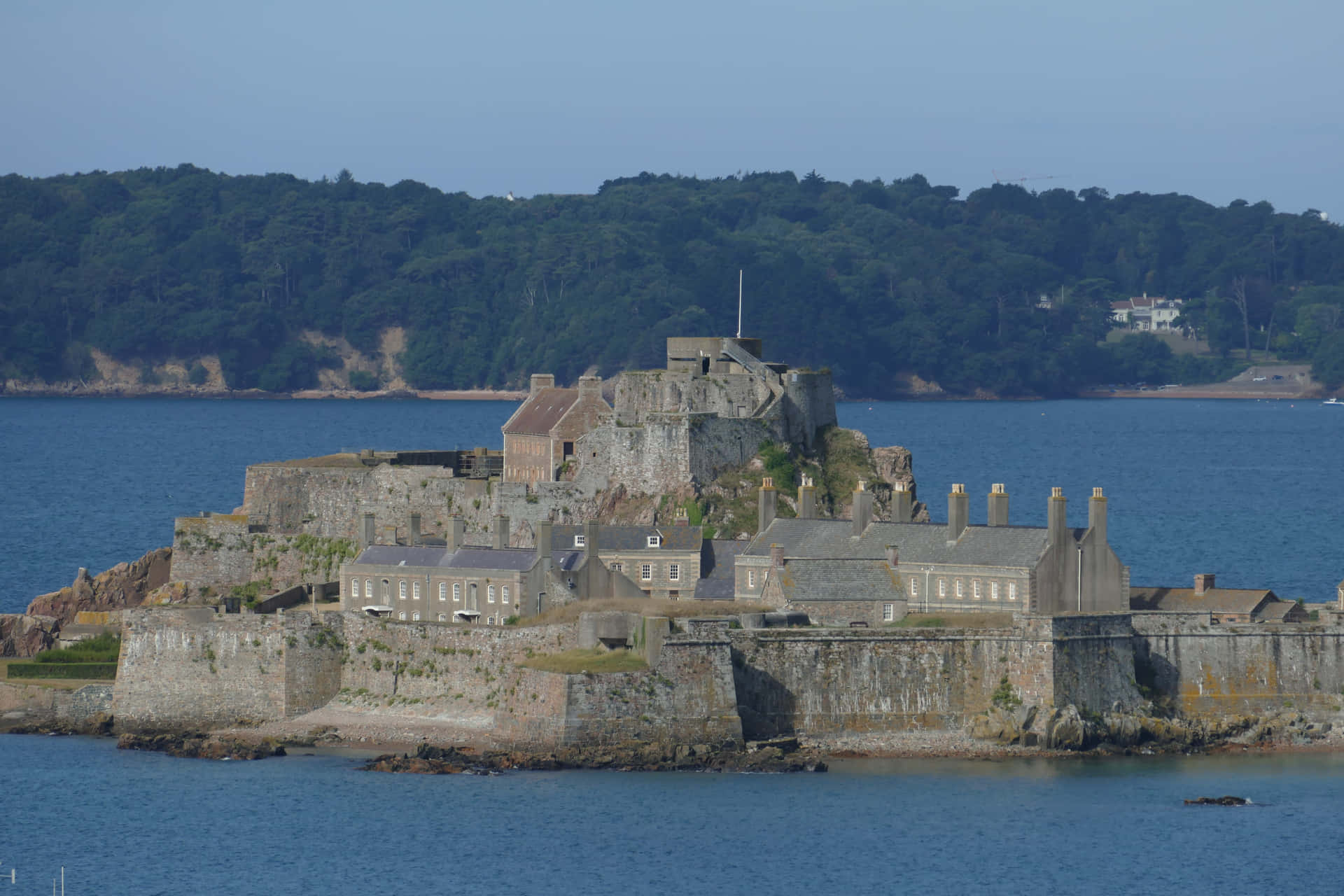 Coastal Fortress Overlooking Sea Background