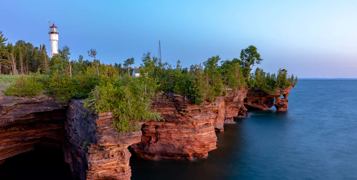 Coastal Lighthouse Over Sea Caves