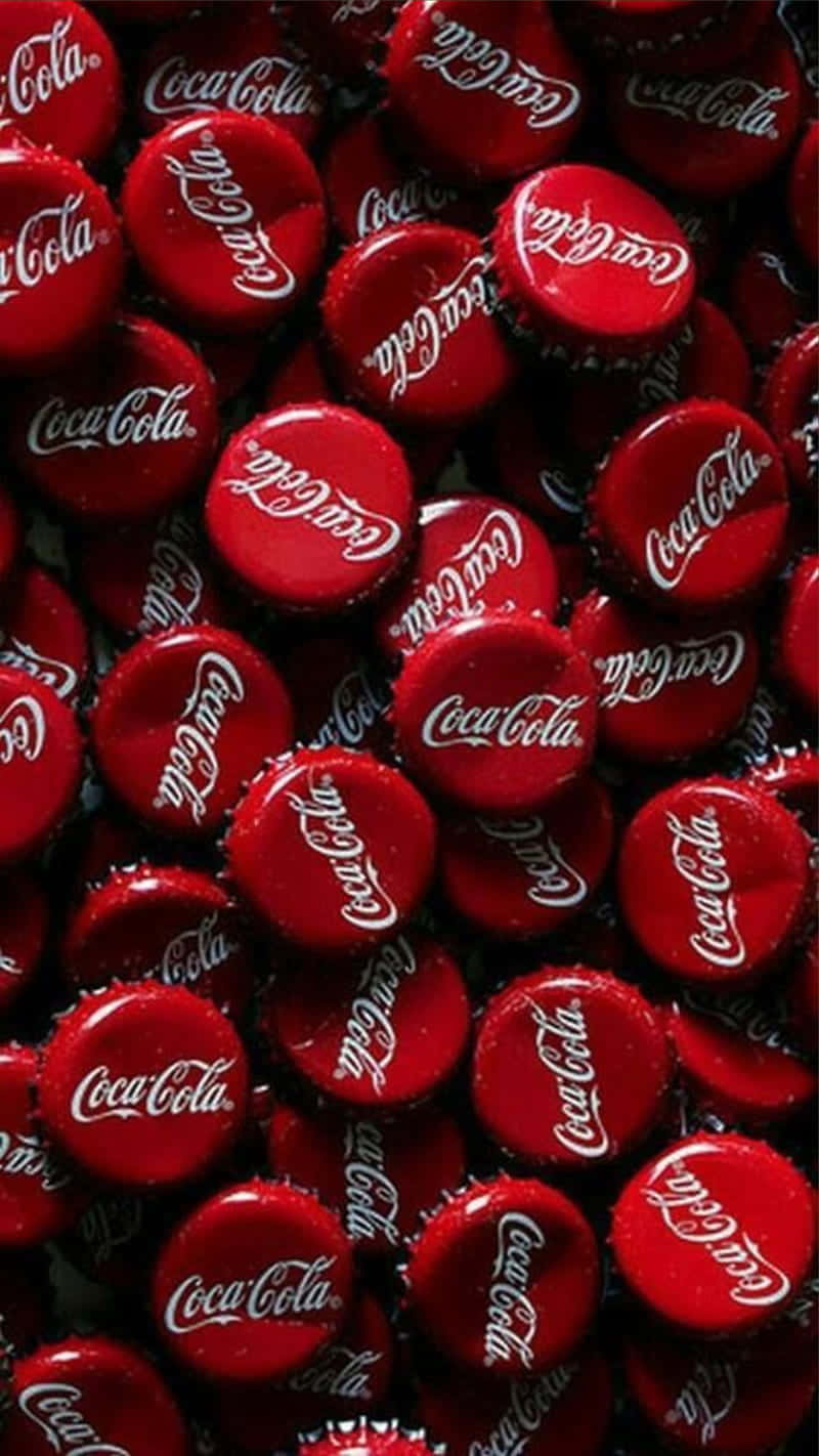 Coca Cola Bottle Caps In A Pile Background