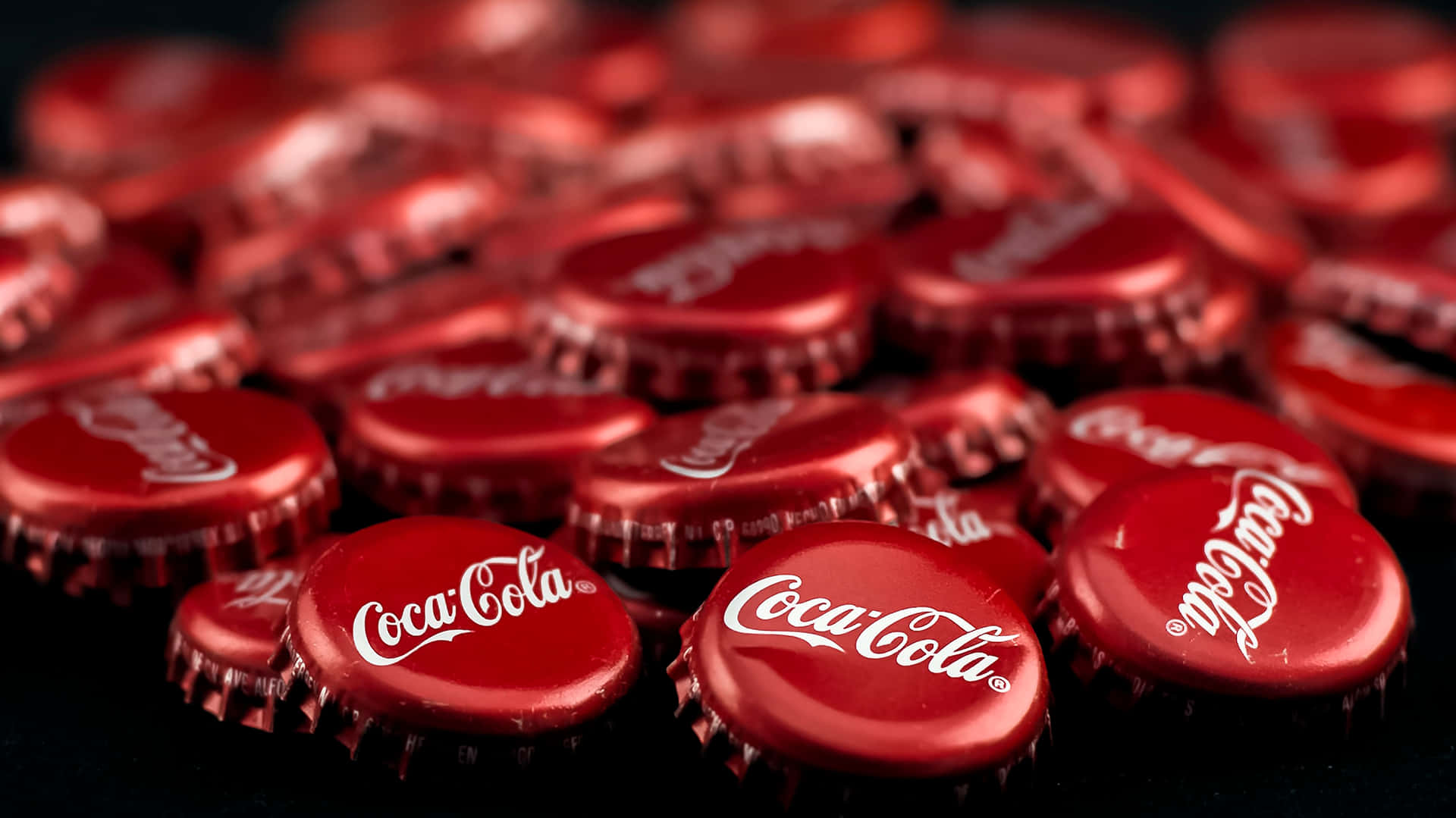 Coca Cola Bottle Caps On A Black Background Background