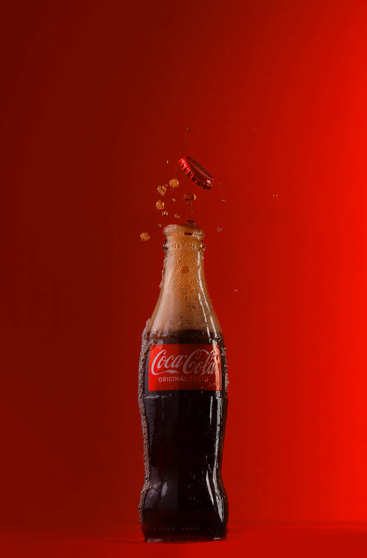 Coca Cola Bottle Falling On Red Background Background