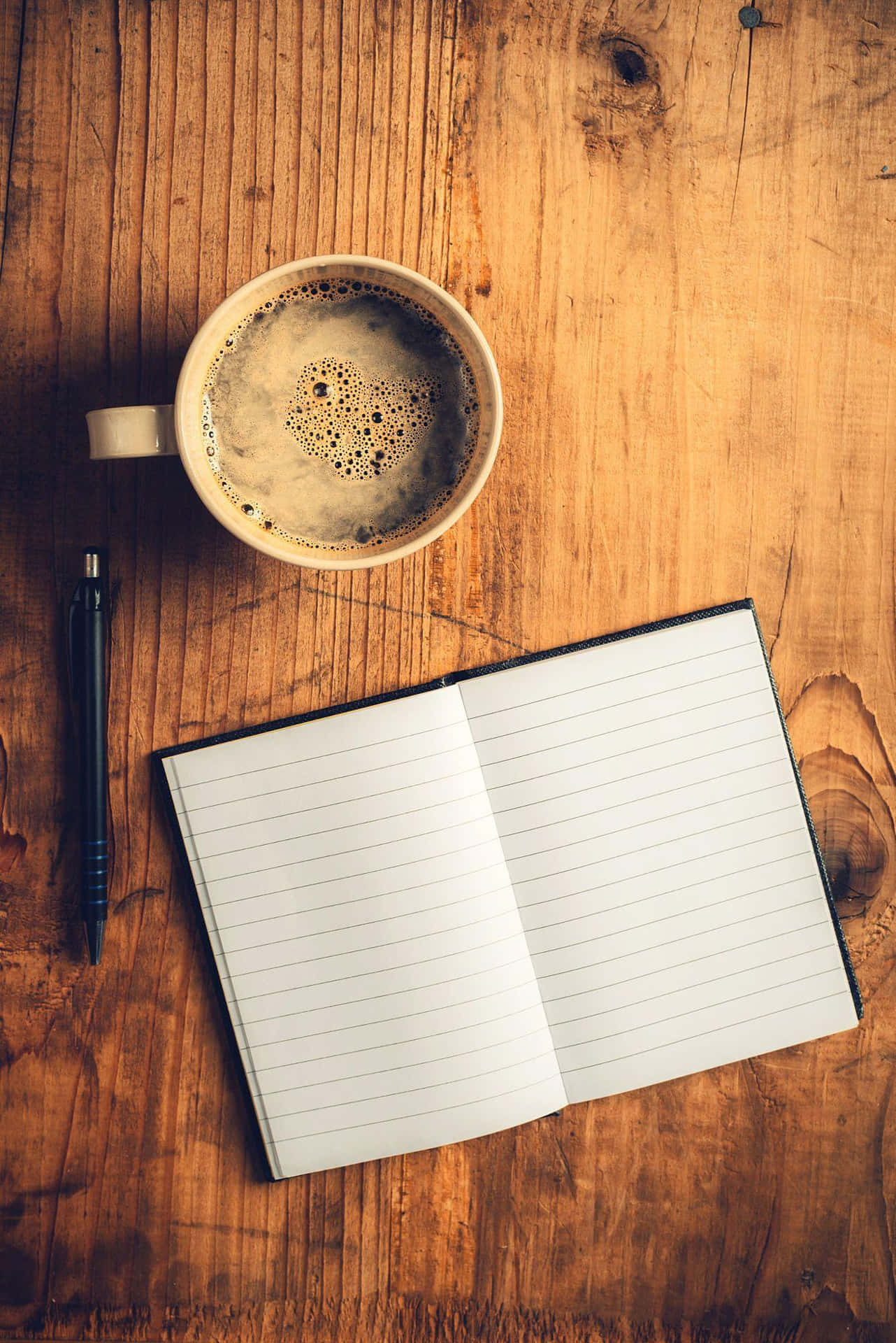 Coffeeand Notebookon Wooden Table Background