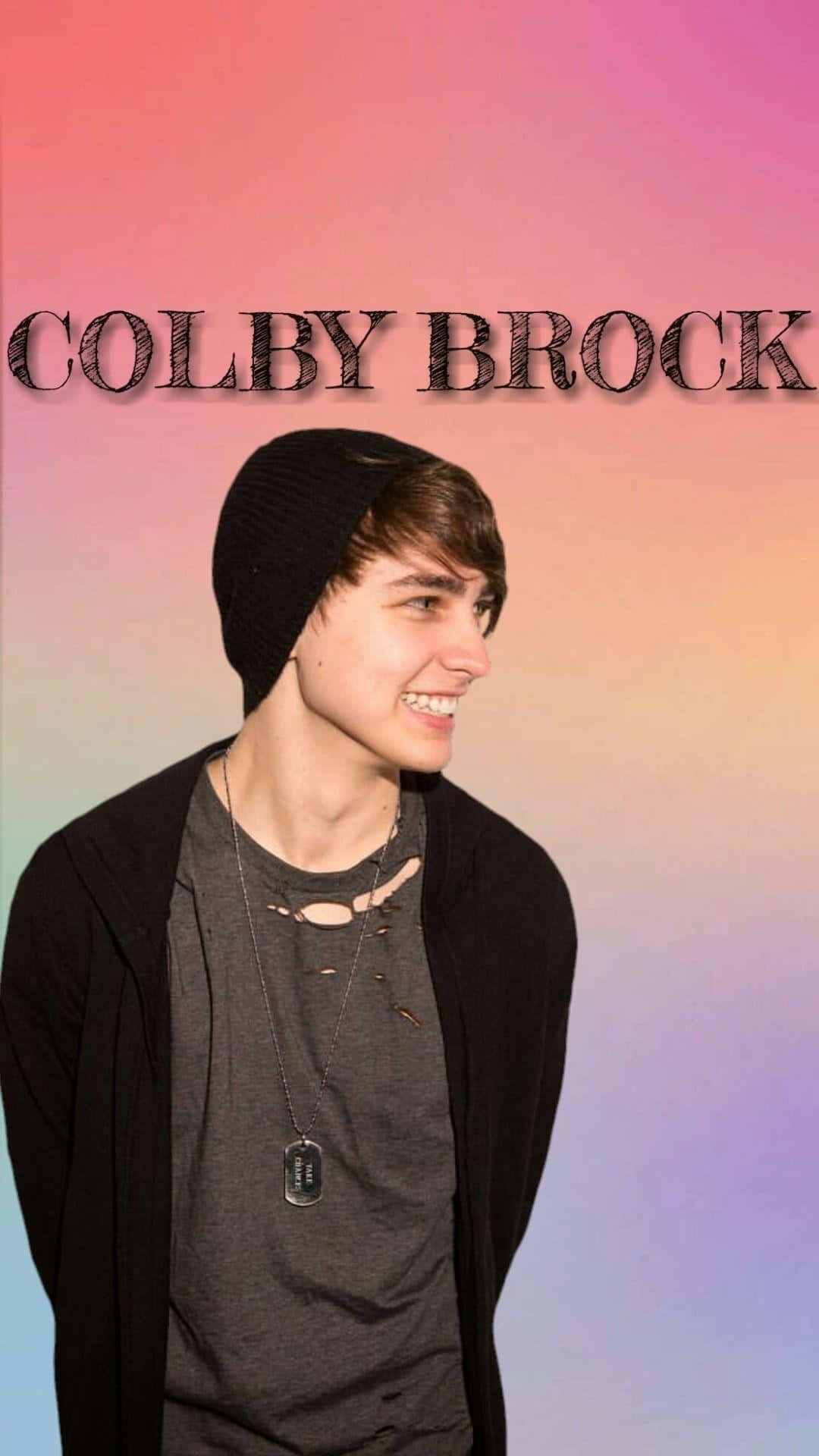 Colby Brock Strikes A Winning Pose In A Featured Photo. Background