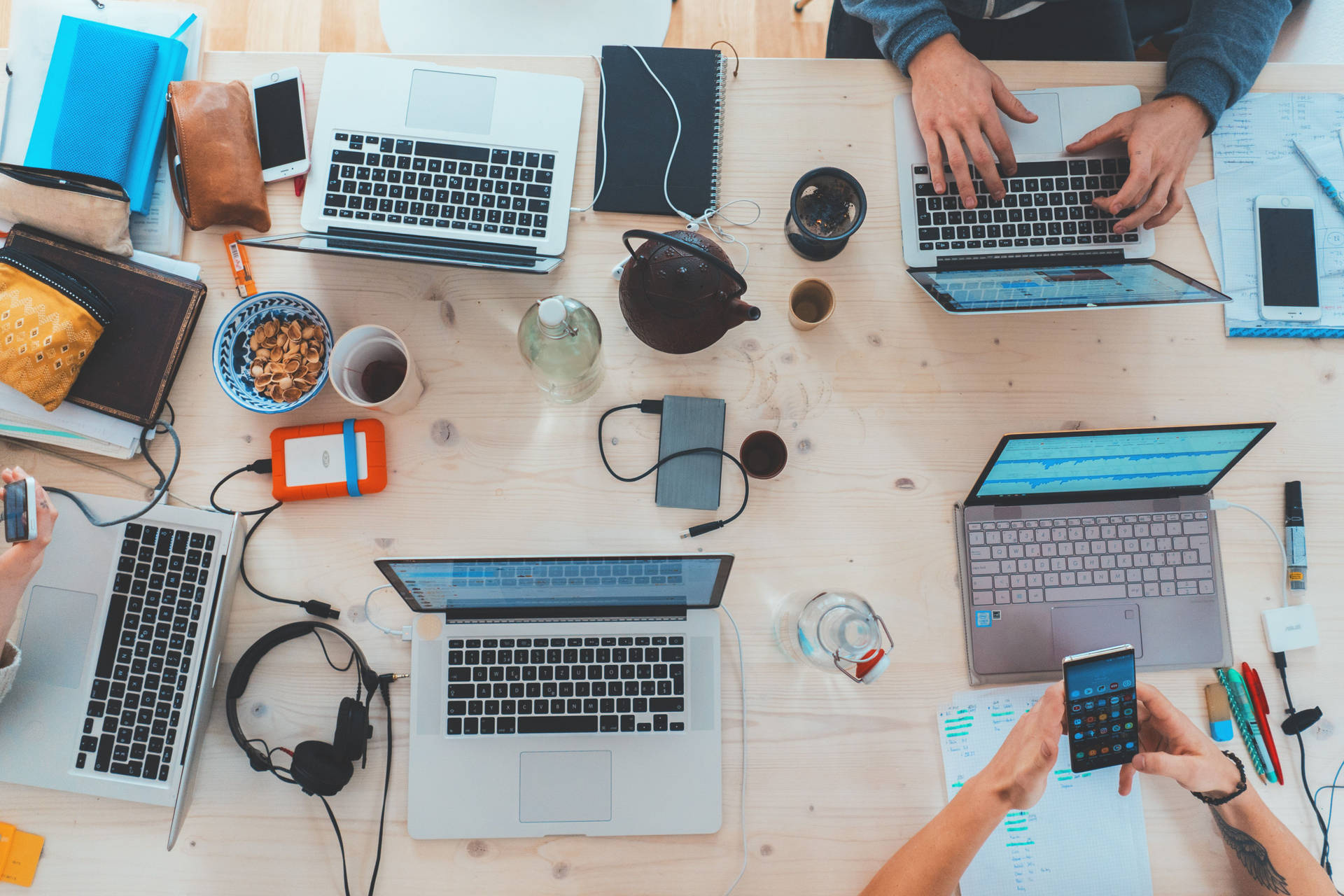 Collaborative Meeting At Laminated Office Desk Background