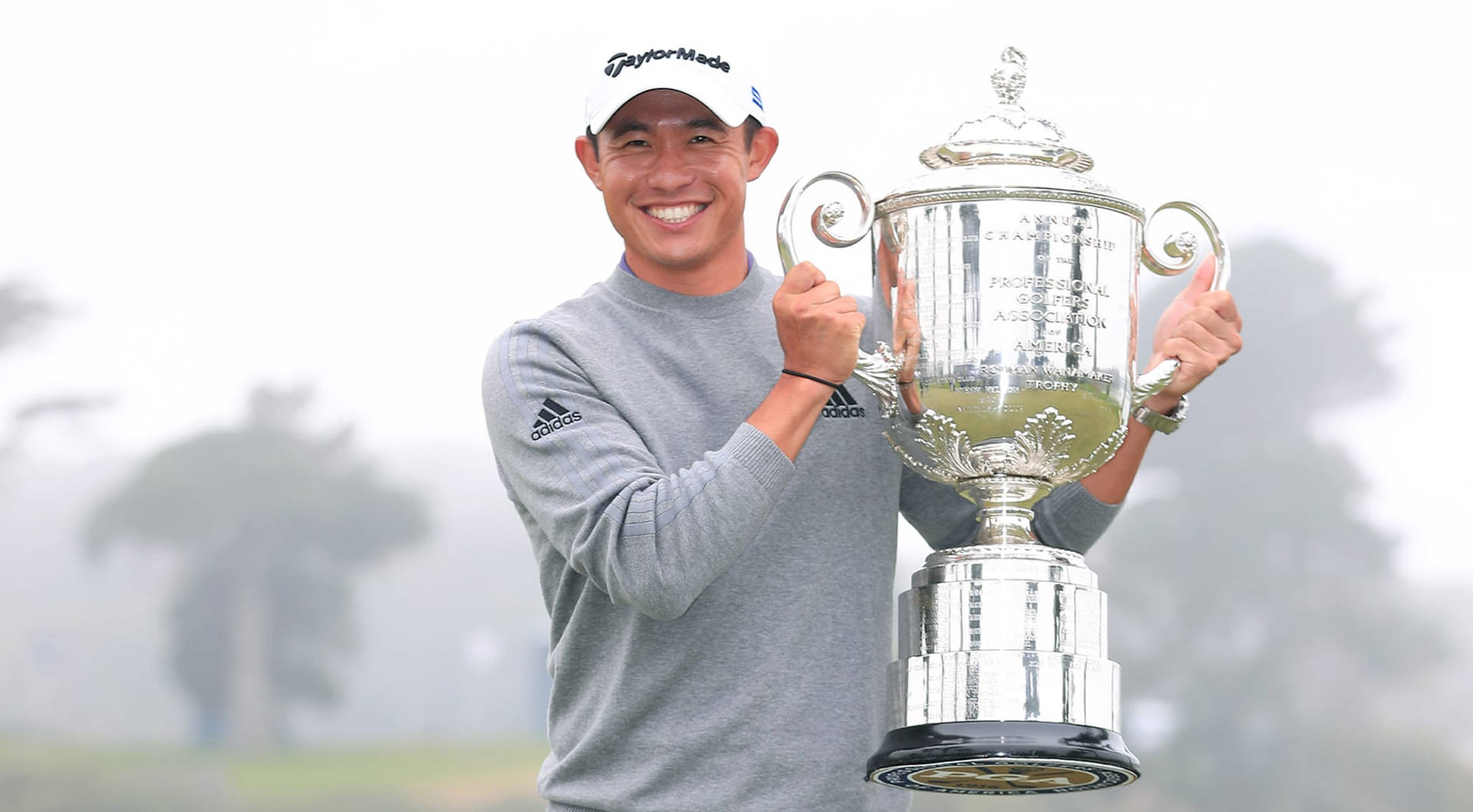 Collin Morikawa Holding His Pga Trophy Triumphantly Background