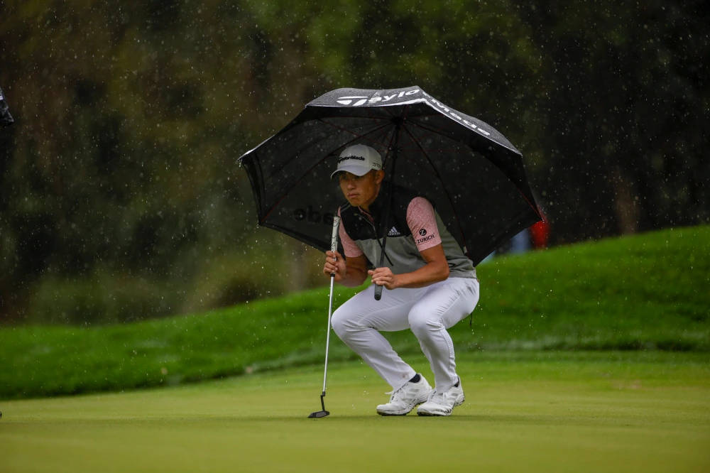 Collin Morikawa Under An Umbrella